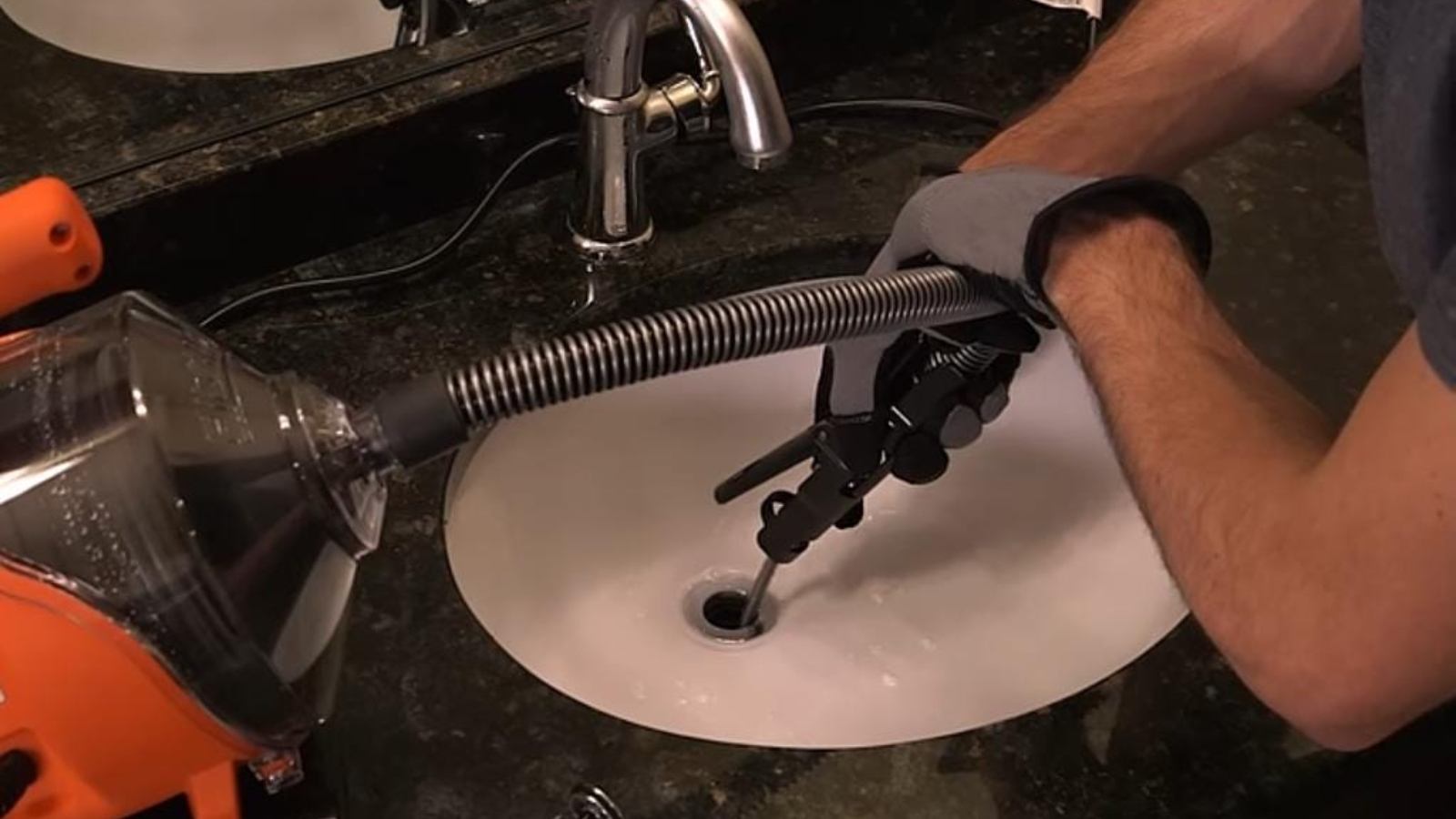 Plumber clearing a drain with a snake in a Torrance home