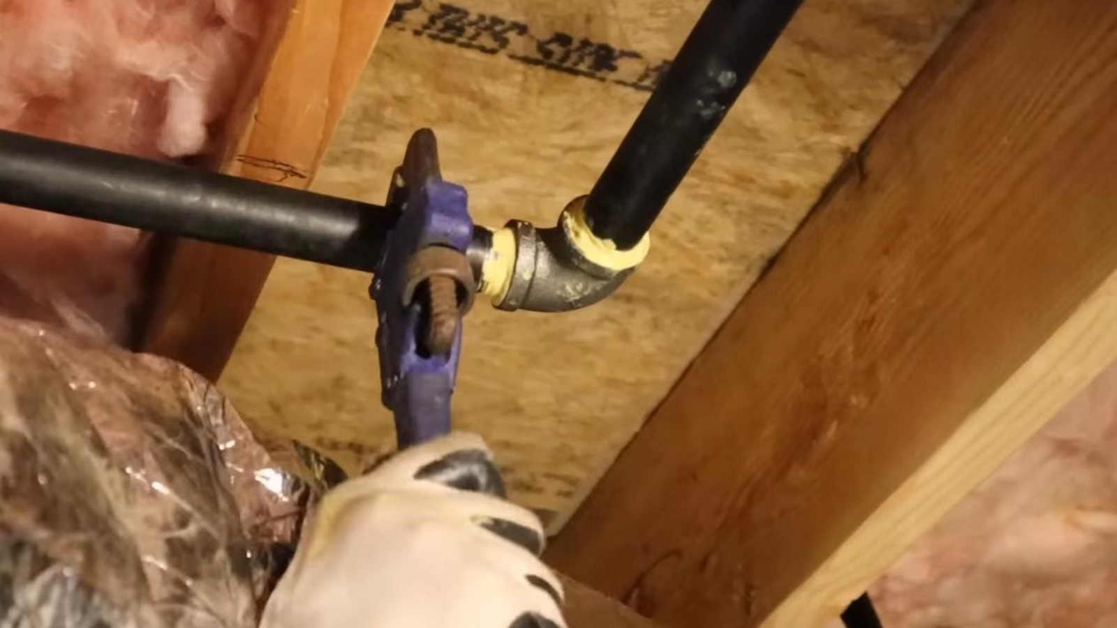 Plumber working on a gas line connection