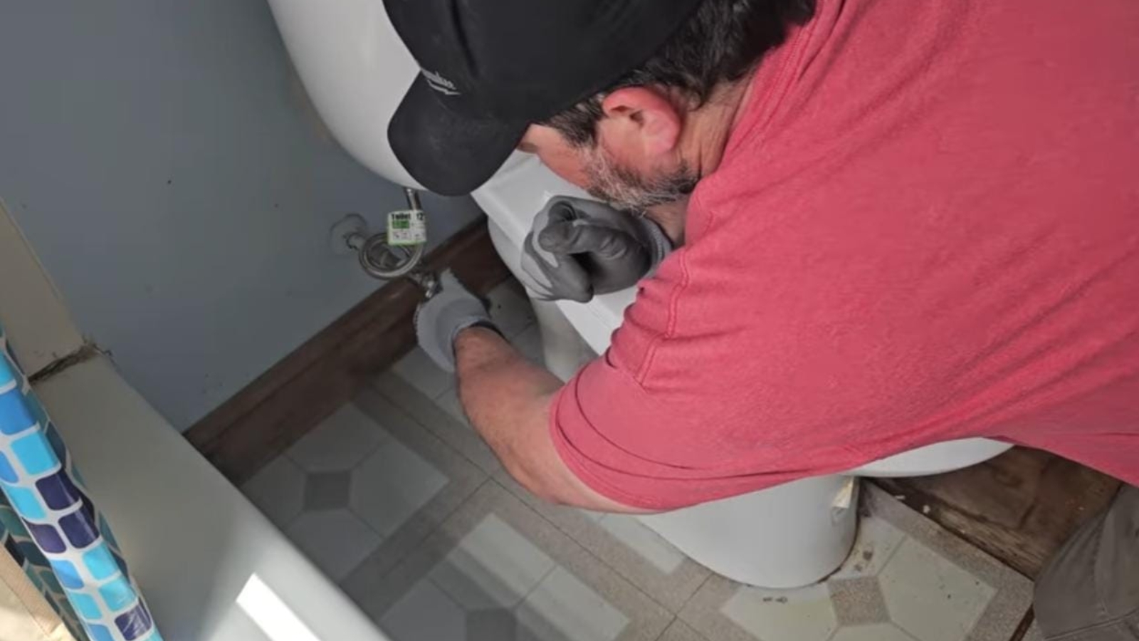 Plumber installing a toilet