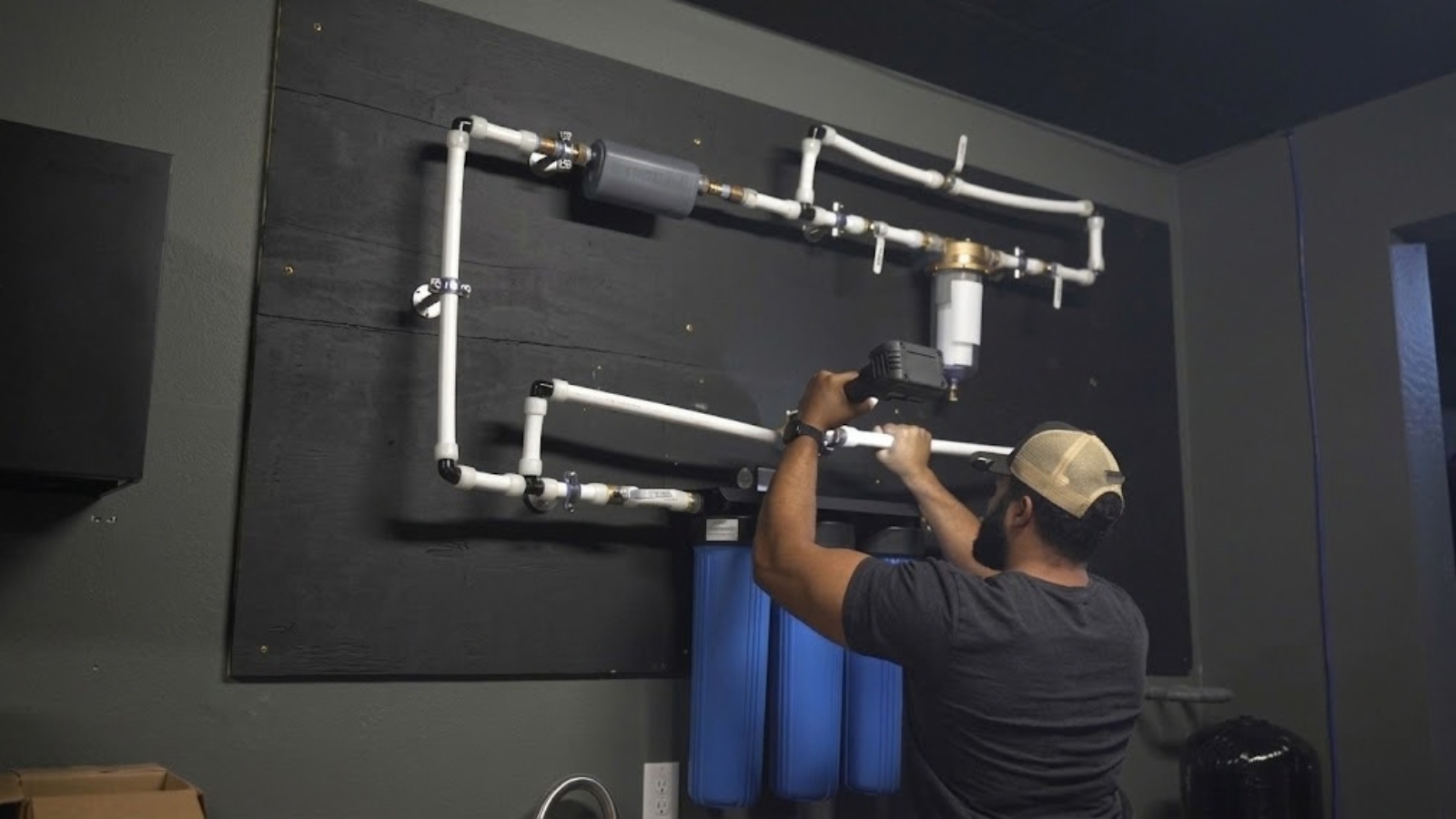 Whole-home water filtration system installed in a garage